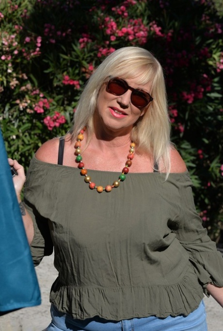 Fat blonde Melody fondles her breasts while outdoors in sunglasses