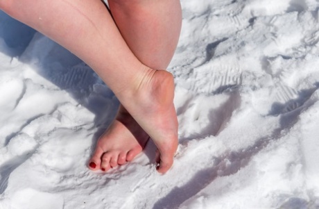 BBW solo girl is ball gagged and bound on snow-covered ground in the nude