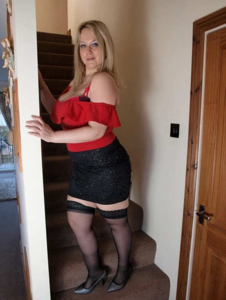 Blonde BBW Sindy Bust unveils her huge tits and big butt on the stairs