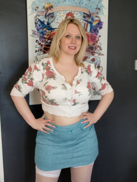 Blonde BBW Sindy Bust gets naked on a chair in white stockings