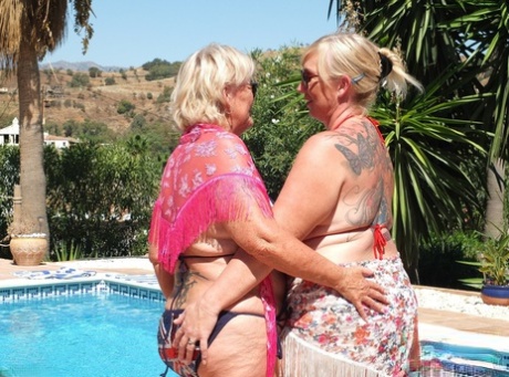 Mature blonde fatty Melody and her lesbian lover sport bikinis and sunglasses