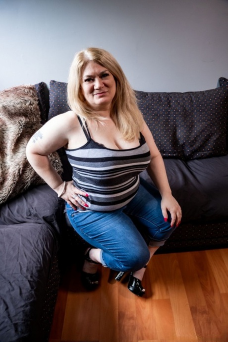 Obese blonde Geisha Sonia has sex with her man friend on a sofa