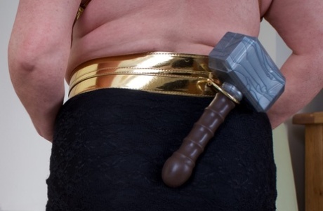 Older lady Speedy Bee wields a mallet while showing her natural tits and pussy