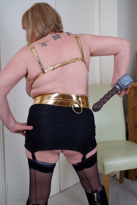 Older lady Speedy Bee wields a mallet while showing her natural tits and pussy