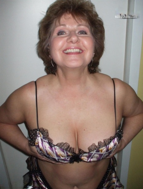Older woman Busty Bliss models lingerie before playing with a cock