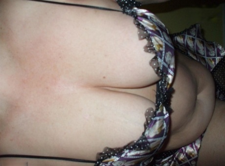 Older woman Busty Bliss models lingerie before playing with a cock