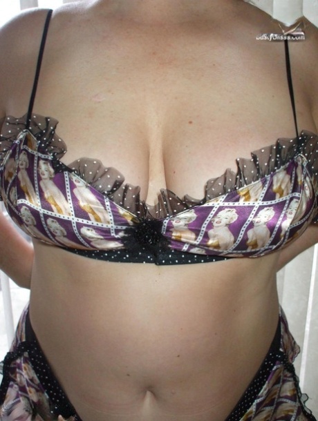 Older woman Busty Bliss models lingerie before playing with a cock