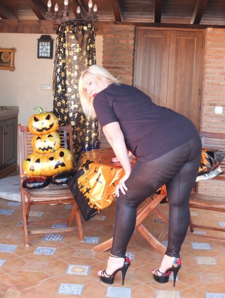 Thick older blonde Melody shows her big ass while wearing a thong