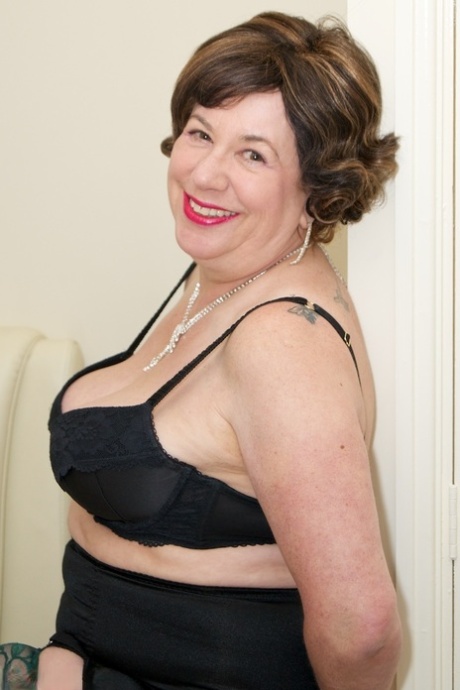 Older lady Dirty Doctor unveils her natural tits and bald pussy in sexy nylons