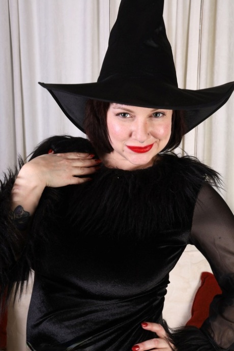 30 plus woman Satine gets naked while wearing a witch's hat