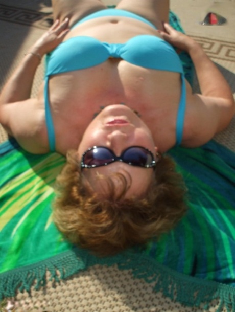 Chubby older woman Busty Bliss releases her natural tits from a bikini