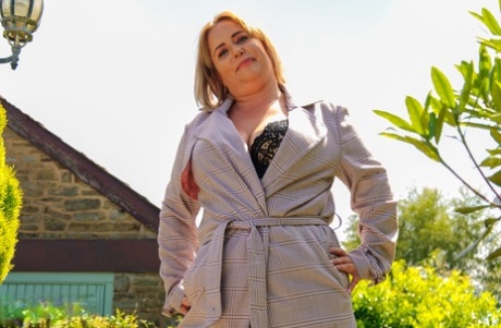 Mature British fatty Mia Daniels masturbates with a sex toy in stockings