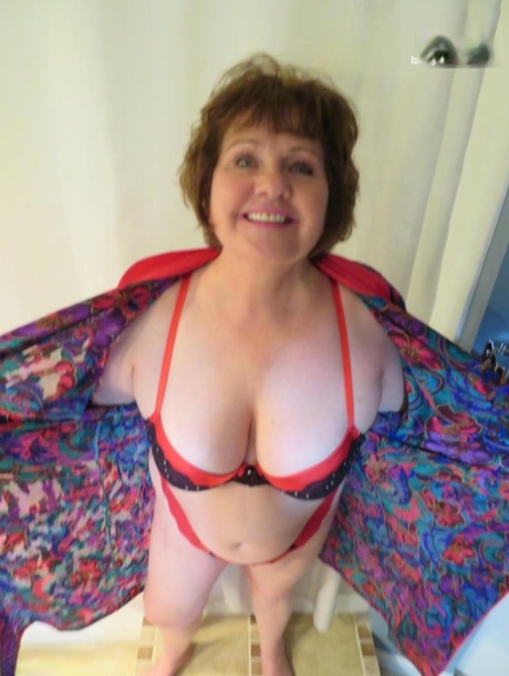 Mature lady Busty Bliss plays with a penis in her glasses and underthings