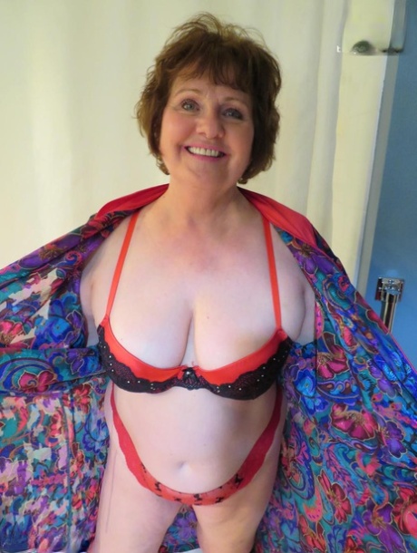 Mature lady Busty Bliss plays with a penis in her glasses and underthings