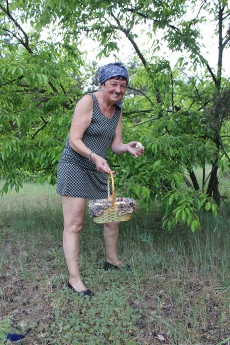 Old woman Hanna D has sex on a blanket in a field with a younger man