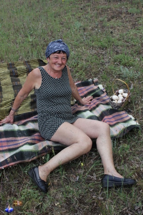 Old woman Hanna D has sex on a blanket in a field with a younger man