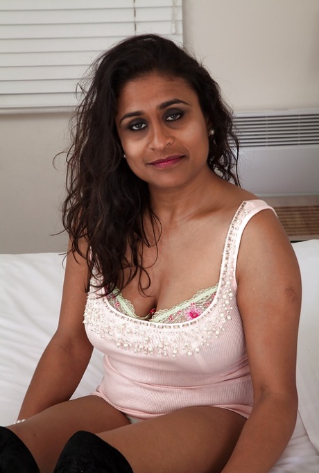 Sassy mature gal uncovering her chubby curves and exposing her shaggy cunt