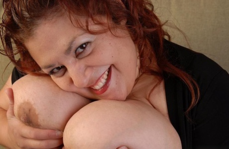 Fatty mature brunette Reyna undressing and demonstrating her tits