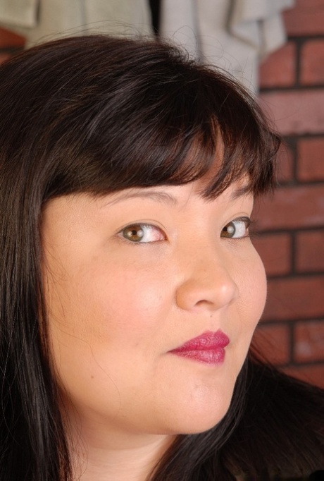 Fatty Asian mature Olivia slowly takes off her tight clothes