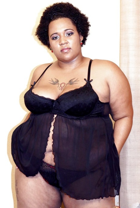 Mature ebony fatty Kitten posing for solo shoot in lingerie and heels