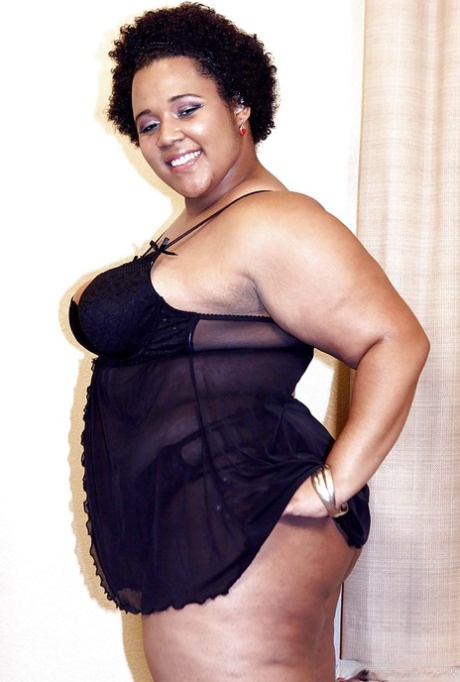 Mature ebony fatty Kitten posing for solo shoot in lingerie and heels