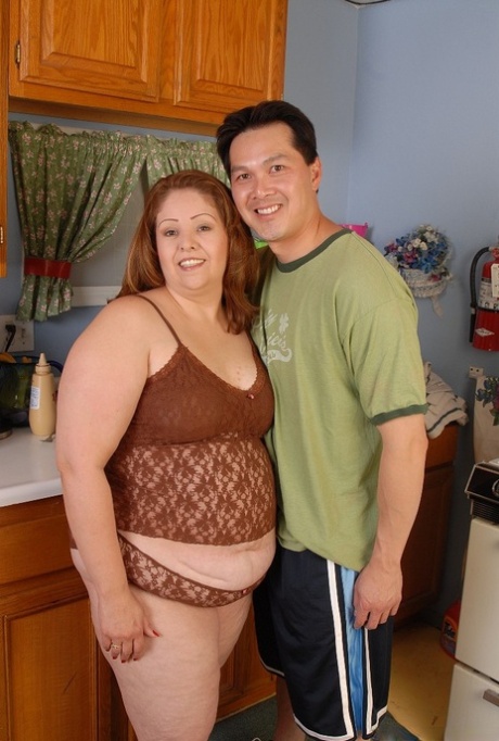 Overweight housewife Cyn eating cumshot out of hand in kitchen