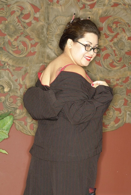 Naughty asian plumper in glasses uncovering her big flabby tits