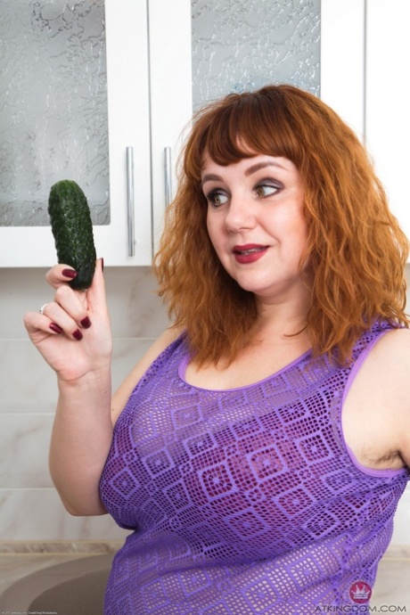 Chubby wife Katrin Porto plays with a cucumber after revealing her hairy twat