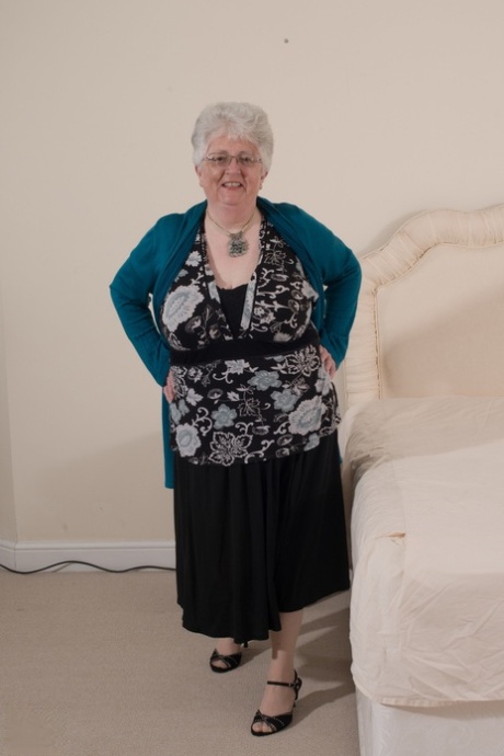 Kinky granny Caroline V fondles her big breasts & toys her fat pussy on a bed