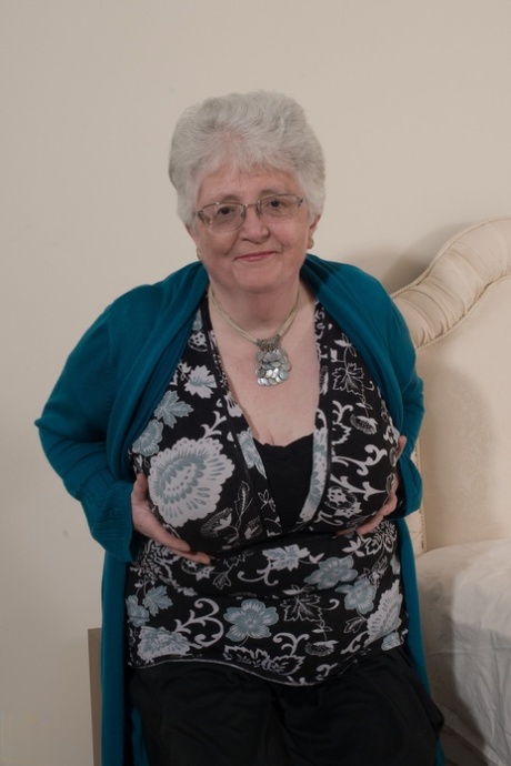 Kinky granny Caroline V fondles her big breasts & toys her fat pussy on a bed