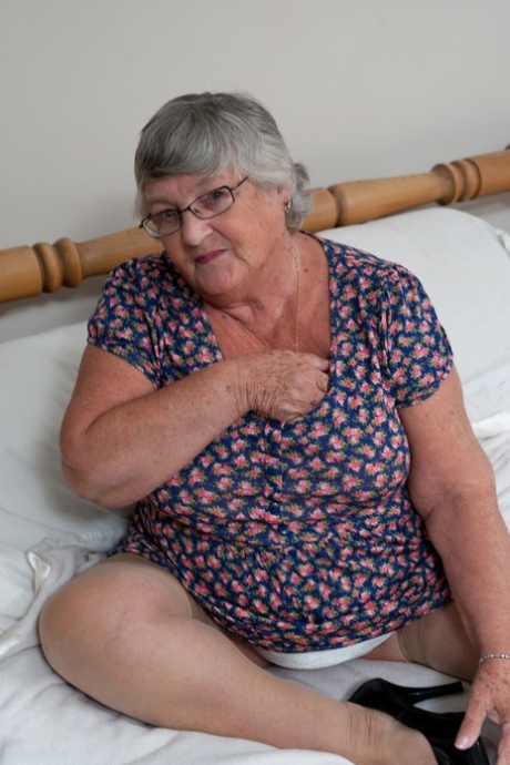 Fat granny with eyeglasses Libby strips naked and fucks a sex toy