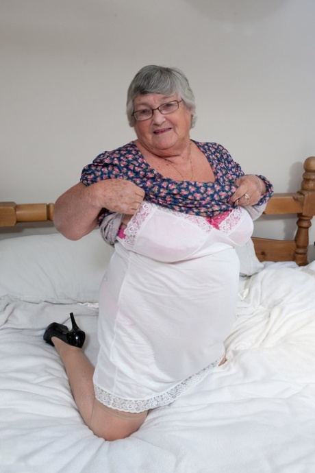 Fat granny with eyeglasses Libby strips naked and fucks a sex toy