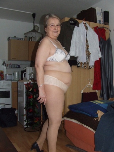 Fat European granny Sybille stripping off her clothes and skin tone tights