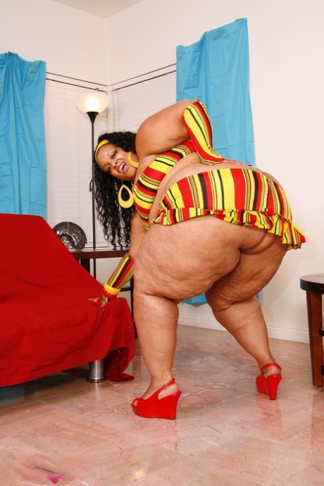 Fat ebony with a huge ass Farrah Foxxx strips and poses nude in a solo