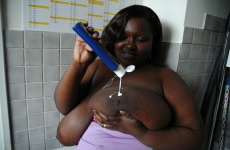 Mature BBW ebony Mariana Kodjo oiling & massaging her massive tits