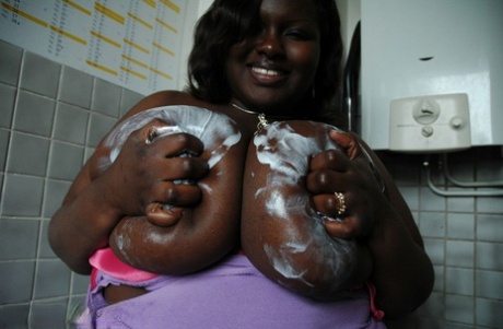 Mature BBW ebony Mariana Kodjo oiling & massaging her massive tits