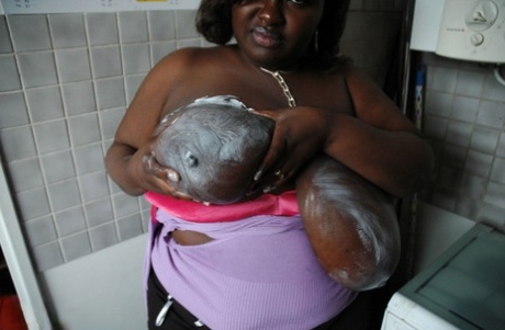 Mature BBW ebony Mariana Kodjo oiling & massaging her massive tits