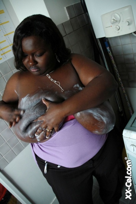 Mature BBW ebony Mariana Kodjo oiling & massaging her massive tits