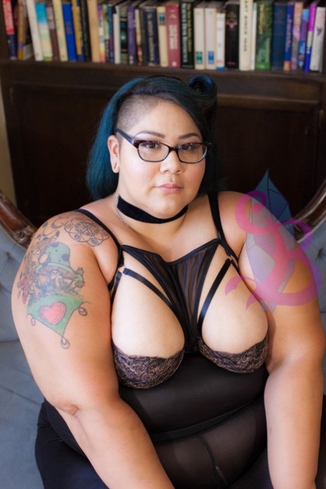 Tattooed SSBBW Crystal Blue teasing with her juicy natural tits in glasses