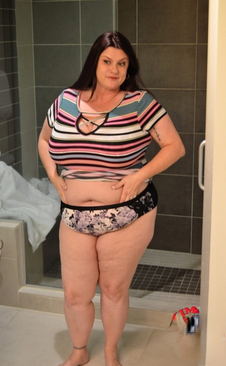Gorgeous MILF fatty Kimmie Kaboom showering her big natural tits with milk