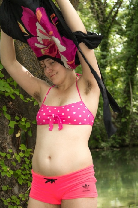 Brunette teen with tiny tits Clarissa exposes her hairy armpits in the woods
