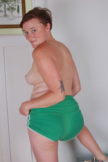 Amateur teen with tattoos Annie displays her hairy pussy on a fitness ball
