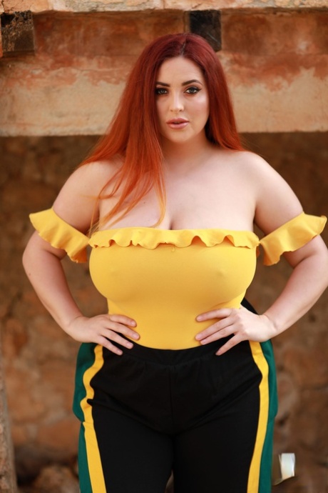 Redheaded fatty Lucy Vixen strips outdoors and shows off her big boobs
