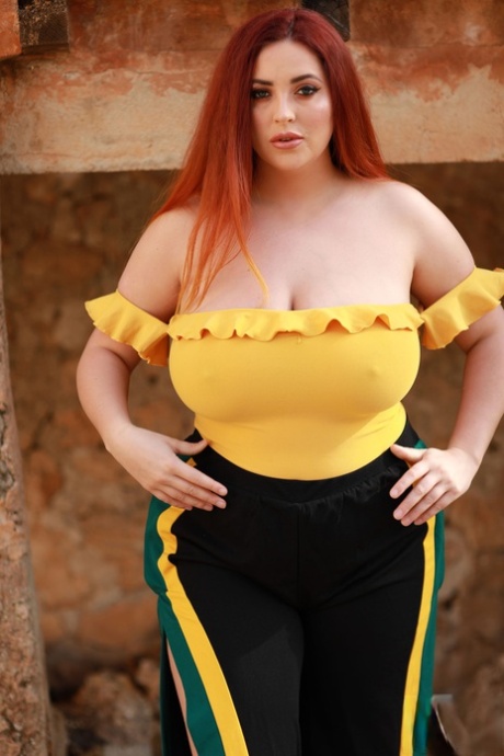 Redheaded fatty Lucy Vixen strips outdoors and shows off her big boobs