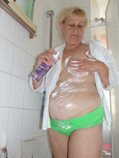 Mature housewife Dagmar puts whipped cream all over her body before washing it