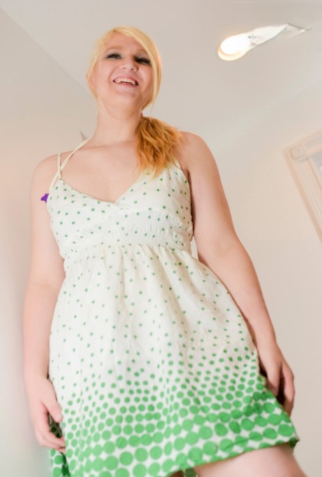 Curvy blonde shemale Ashlee Alespia loses her clothes and masturbates