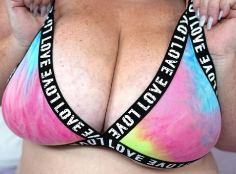 BBW Danica Danali takes a cumshot on her big boobs while teasing on her bed