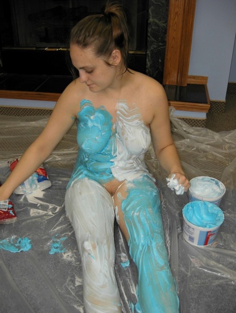 Busty babe Danni gets her naked body and big tits messy with paint and sweets