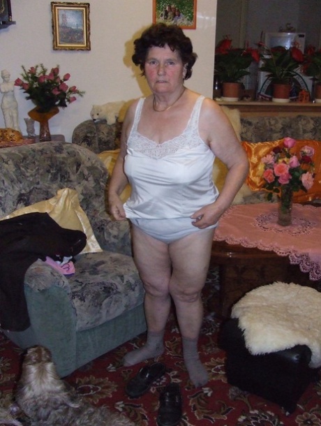 Mature fatty Hildegard strips and shows her huge tits and ass in a solo