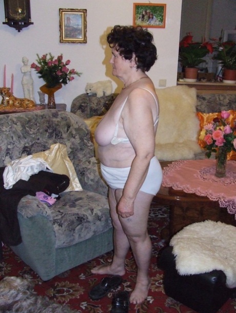 Mature fatty Hildegard strips and shows her huge tits and ass in a solo